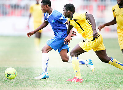 Striker Kambale Salita dribbles past URA defender Musa Docca before  scoring his first goal for Rayon Sports yesterday at Al Nugga stadium. The New Times / B. Mugabe.