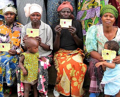 Women posing in a group photo with Mutuelle de Santu00e9. Districts have promised to increase health insurance coverage. The New Times/File