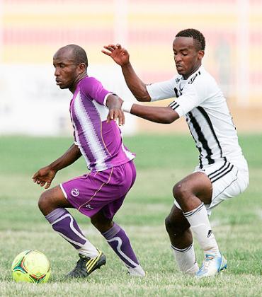 Vitalu2019O's Christian Mbirizi shields the ball from APR's Yannick Mukunzi during the group stage game. Today, both teams clash again in the Kagame Cup title match. The New Times / B. Mugabe