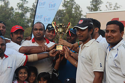 Challengers cricket club players pose with the trophy after winning the 2013 Computer Point T20 tournament on Sunday.  The New Times / Courtesy