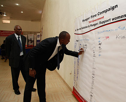 Agriculture ministry Permanent Secretary Ernest Ruzindaza signs a hunger free declaration chart in Kigali. The New Times/ Timothy Kisambira.