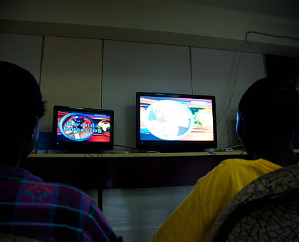 People watch television. All TVs will broadcast digitally once analogue transmission is switched off. The New Times/ Timothy Kisambira.