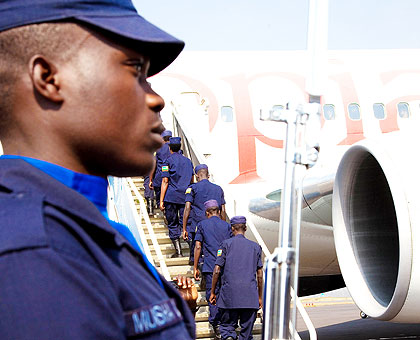 An officer of the Rwanda National Police mounting a guard of honour as the peacekeeping contingent board a flight to Haiti. The New Times/ T. Kisambira.