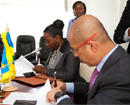 The Minister of State in Charge of Energy and Water, Eng. Isumbingabo, and Atul Punj,  the chairman of Punj Lloyd sign the multimillion deal yesterday.   Saturday Times/ Timothy Kisambira. 