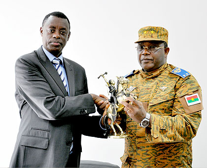 Defence minister Kabarebe and Brig. Gen. Traore exchange a gift yesterday.Saturday Times/ Courtsey. 