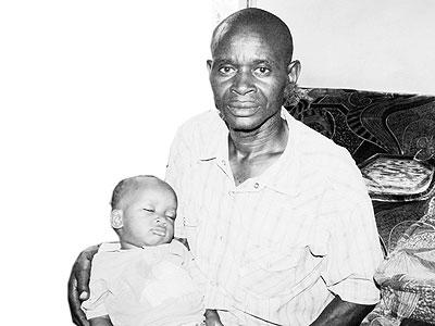 Mzee Antoine Bizimana with one of his u201cchildrenu201d. Sunday Times/Joseph Oindo