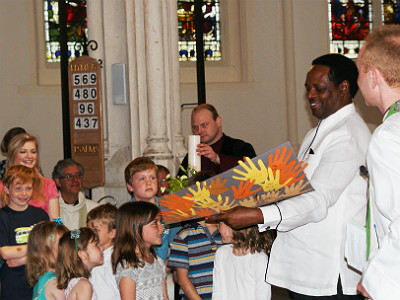 H.E Nkurunziza with children at St Edmunds Cathedral presenting him with an art piece done by them entitled Hands of Friendship to mark the day residents of Bury St. Edmunds, declared ....