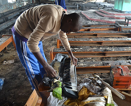 A student rummages through a chapel after one of the three fires that gutted Byimana School of Sciences. The New Times/File