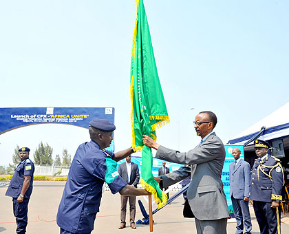 President Kagame receives the African Union flag, shortly before flagging off the u2018Africa UNITEu2019 Command Post Exercise, at the Rwanda National Police Headquarters in Kigali yesterd....