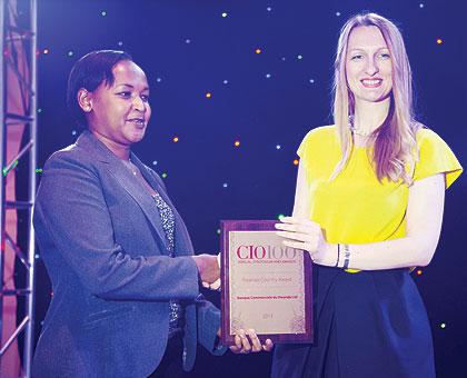 Rosemary Mbabazi, (L) the permanent secretary in the Ministry of Youth and ICT (MYICT), receives an award on behalf of Commercial Bank of Rwanda (BCR). Sunday Times/Timothy Kisambira