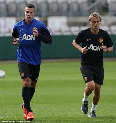 Straight into the action- Robin van Persie warms up alongside United coach Phil Neville in Sydney, hours after arriving for the second leg of the clubu2019s pre-season tour.  Net photo.