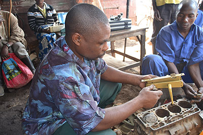 Ndabateze,  tests a key he has finished fabricating.  The New Times/Jean du2019Amour Mbonyinshuti. 