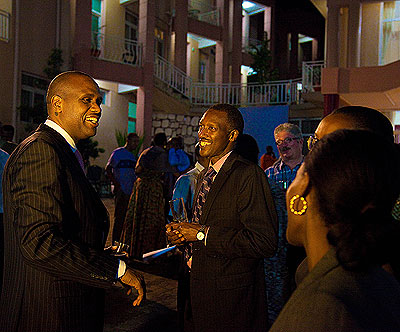 John Mirenge (left), the RwandAir boss and James Ngongo, the director general of multilateral and bilateral    co-operation, share a light moment during the event.