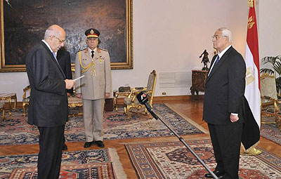 Mohamed ElBaradei, left, is sworn in as interim vice president of Egypt for foreign affairs in Cairo. Net photo.