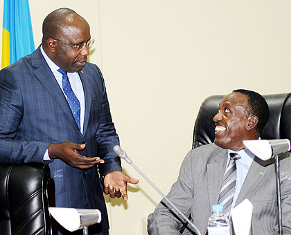 Prime Minister Pierre Damien Habumuremyi (L) chats with Senate President Jean Damascene Ntawukuliryayo at Parliament yesterday. Lawmakers commended the government on achievements in th....