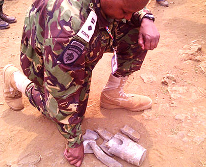 A member of the ICGLR monitors inspects components of the mortar bomb that was fired into Rubavu in Western Rwanda from DR Congo side on Monday. The New Times/Courtesy