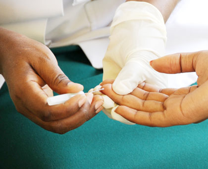 A volunteer testing for HIV at King Faisal Hospital, Rwanda. More than 90 per cent of persons infected with HIV/Aids can now access ARTs that are now available in almost all health fac....
