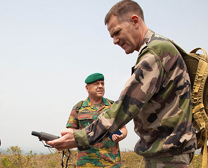 A French officer measures the distance from the site where the bomb landed to the nearest DRC-Rwanda borderline yesterday. The New Times/ T. Kisambira.