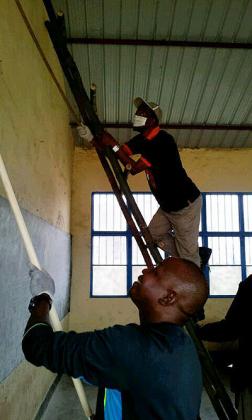 Volunteers paint a classroom at Bisate Primary School in Musanze District as part of celebrations to mark the Nelson Mandela Day yesterday.   The New Times /Courtsey. 