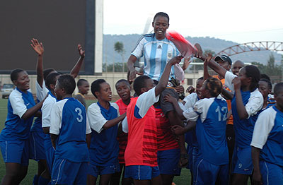 AS Kigali coach Grace Nyinawumuntu is carried shoulder high by her players after winning the league last year.  The New Times / File.