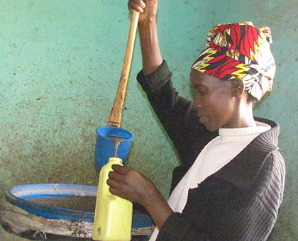 A member of Nozisuku coop serve sorghum beer to clients.   Saturday Times/Jean Pierre Bucyensenge. 