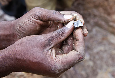 A miner displays a wolfram stone. The mining industry failed to attract enough investors in the past six months.  The New Times / File