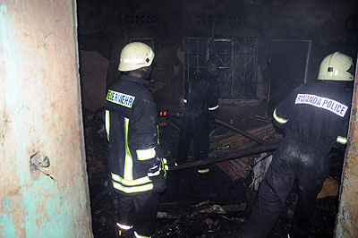 Police firemen putting out a fire Quartier Matheus, where businesses were gutted by fire on Saturday . The New Times / John Mbanda