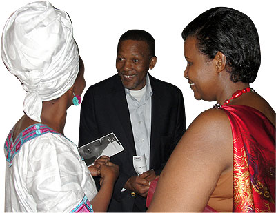 The South African High Commissioner to Rwanda George Nkosinati Twala (C) and Gender and Family Promotion Minister Oda Gasinzigwa (R) share a light moment at the screening of u2018Mama Af....