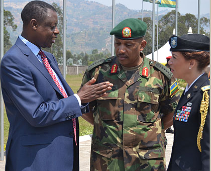 Minister Kabarebe, Chief of Defence Staff General Patrick Nyamvumba and the US Military Attachu00e9, Lt Col Gwyn A. Carver, chat after the official opening of  the Senior Staff Course yes....