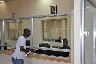 A migration officer attends to a traveller at newly-launched Ruhwa one-stop border post. Transit across the Rwanda-Burundi border will be more flexible under the new system. The New Ti....