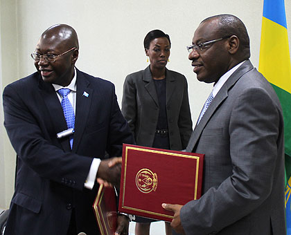 Manneh and Gatete after signing the deal yesterday. The New Times/John Mbanda