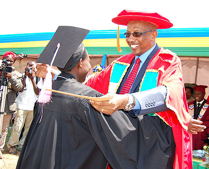 Acting Executive Director for the National Council of Higher Education, Dr. Innocent Mugisha, congratulates the best student. Saturday Times/Stephen Rwembeho.