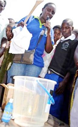 An SFH community officer demonstrates to Bugesera residents how to use Suru2019Eau. Courtesy photo.