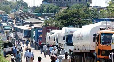 Fuel and cargo trucks line up to clear with customs at the border. Such queues will be history after the new tax deal comes into force. The New Times / File 