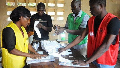 Members of Togo's Independent National Electoral Commission (CENI) sort out valid votes on July 25, 2013 in Lome, during the country's parliamentary elections. Togo's ruling party has ....