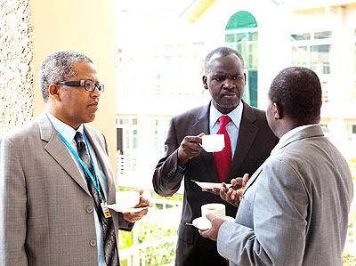 Desanker (L) and Kamanzi (C) listen to Tanzaniau2019s Richard Muyugi, the chairperson of UNFCCC, during coffee break at the conference yesterday. The New Times/ T. Kisambira.