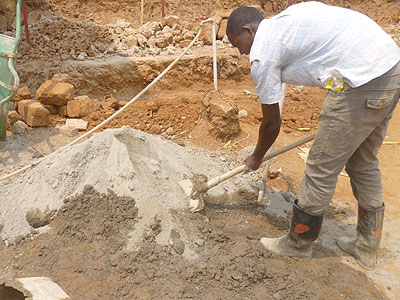 A worker mixes sand and cement at a construction site in Kigali. RBS has started a drive to sensitise the public about standards of products, including building materials. The New Times/File