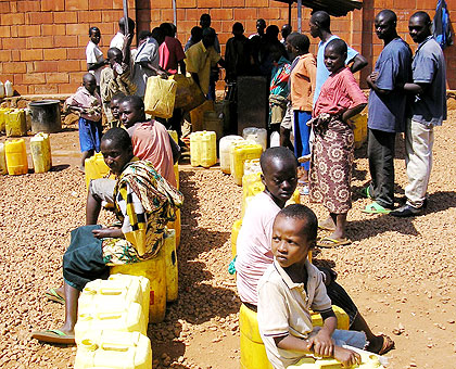 City suburb dwellers queue for water during a past shortage. Officials have blamed current shortage on dry spell and human behaviour. The New Times/File