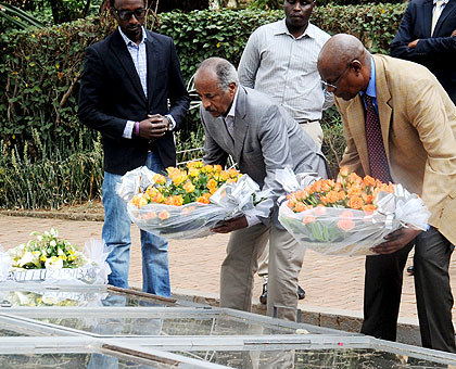 Eritrean Foreign Affairs minister Osman Saleh, (C)  and RPF Commissioner Joseph Karemera lay wreathes at the Kigali Genocide Memorial Centre yesterday.  The New Times/John Mbanda. 