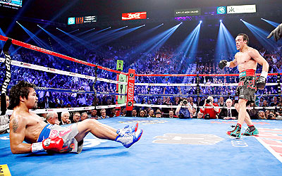 DOWN BUT NOT OUT; Pacquiao (on the floor) suffered a brutal sixth-round knockout by Juan Manuel Mu00e1rquez (R) in December. Net photo.