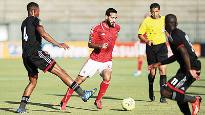 Al Ahly playmaker Mohamed Aboutrika (C) attempting to go past Orlando Pirates defence on Sunday. Net photo