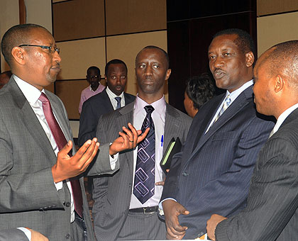 Central bank Governor John Rwangombwa (L) chats Development Bank of Rwanda CEO Alex Kanyankole (C), Bank of Kigali CEO, James Gatera (2R)  and Kenya Commercial Bank MD Maurice Toroi....