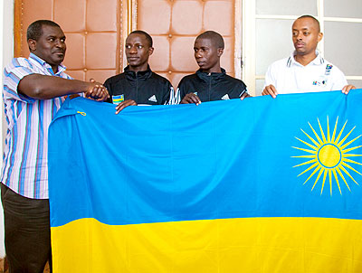 The Director of Sports Emmanuel Bugingo handing over the national flag to Team Rwanda at Amahoro stadium yesterday. The New Times/ T. Kisambira.