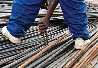 A worker at a steel bar making factory. Local producers have been challenged to improve product quality to be competitive in the EAC market.  The New Times / Timothy  Kisambira