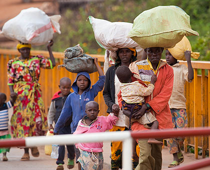 A Rwandan family returns from Tanzania yesterday. Many Rwandans crossed the Rusumo border on the final day of the deadline set by the Tanzanian governent.   Saturday Times/ Timothy Kis....