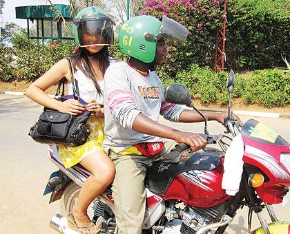 Even though passengers donu2019t seem comfortable with the arrangement of having to don helmets that are worn by other people, few ever complain. Sunday Times/Internet photo