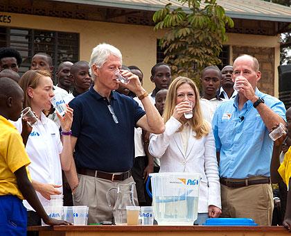 The Clintons drinking water after purifying it. This was part of CGI and Procter and Gambleu2019s Commitment to Save One Life Every Hour u2013 a campaign dedicated to providing clean drinking water to areas in need. Sunday Times/File