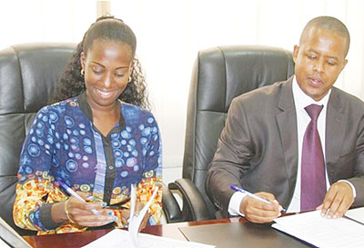  The Director General of WDA Jerome Gasana (R) and Belinda Umurerwa (L) from the Digital Media Group studio signing the MoU. The New Times / Courtesy.