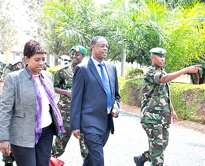 Col. Denis Rutaha, the commandant of the RDF Combined Training Centre , Gabiro, (R) takes top officials, including ministers Muhongayire (EAC affairs), Kabarebe (defence) around the ce....