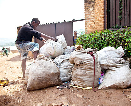 A boy dumps garbage in a neighbourhood in Kanombe Sector. The City of Kigali cleanness campaign seeks to have all households sort garbage before placing for disposable collection, besi....